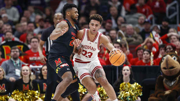 Maryland Terrapins forward Donta Scott (24) defends against Indiana Hoosiers forward Trayce Jackson-Davis (23).